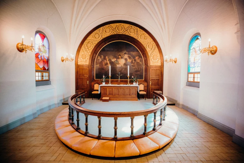 church pews with painted glass on windows in the background