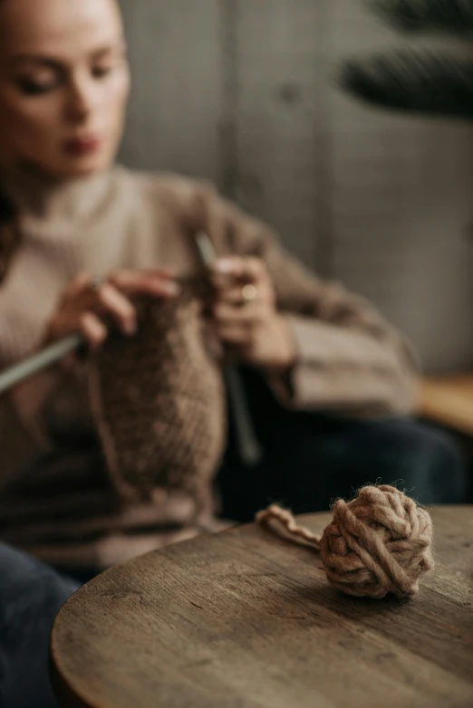 woman knitting in an eclectic home setting