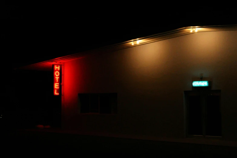 a dark el building lit up with neon lights