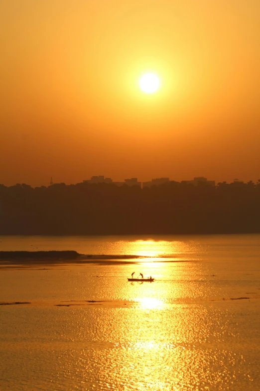 a small boat floating on top of the ocean