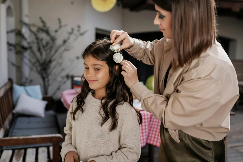 a woman is  a little girl's hair