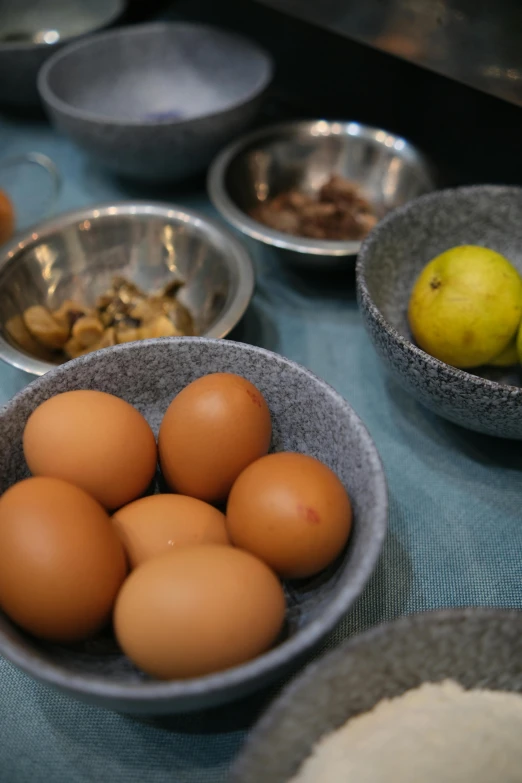 a close up of bowls filled with eggs