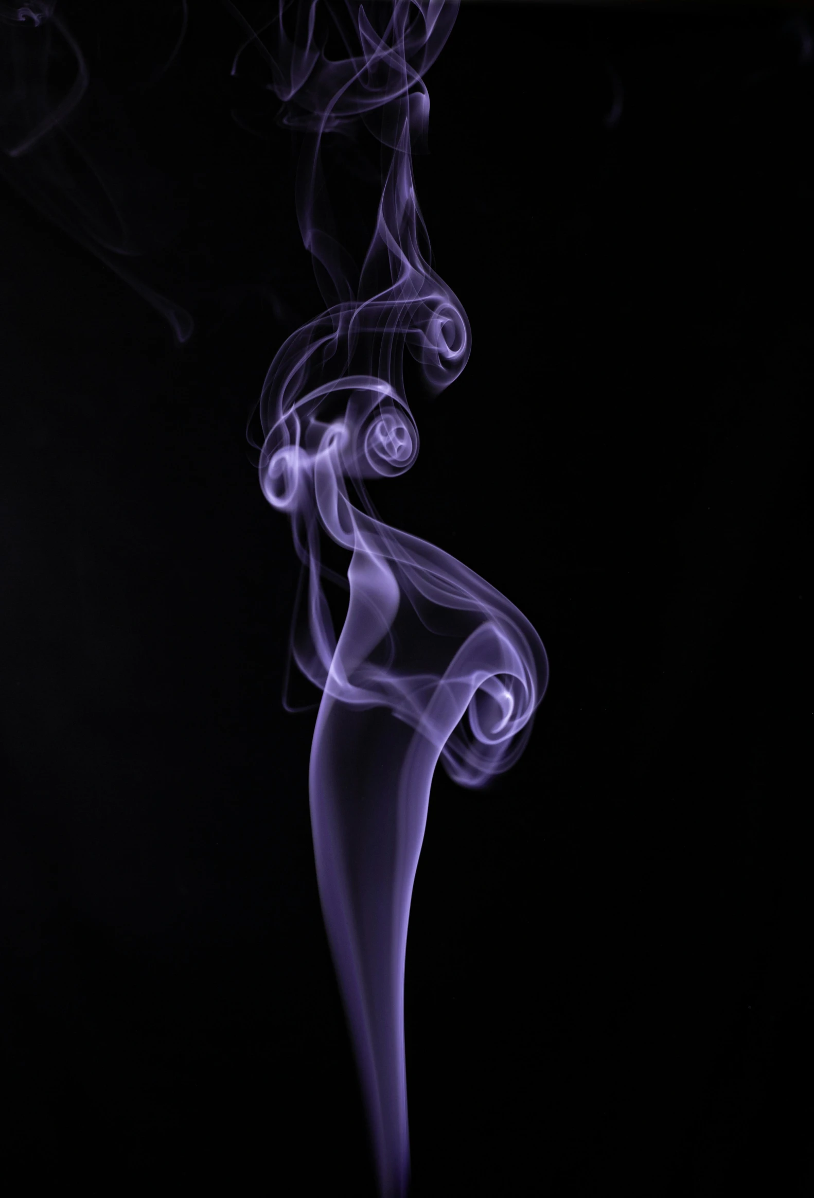 white smoke with eyes and mouth on black background