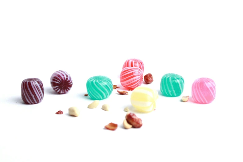 five chocolate candies are arranged with different colored fillings