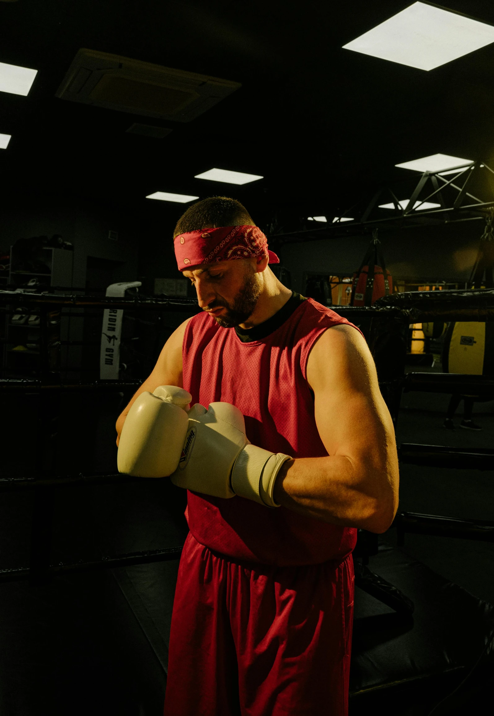 a man in a red wrestling outfit prepares for a match