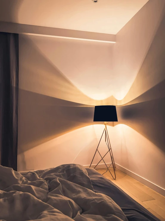 a lamp that is sitting on a bed in a room