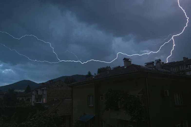 this is an image of lightning strikes over houses