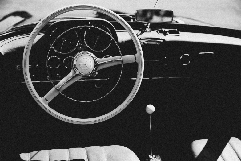 black and white pograph of dashboard of a convertible