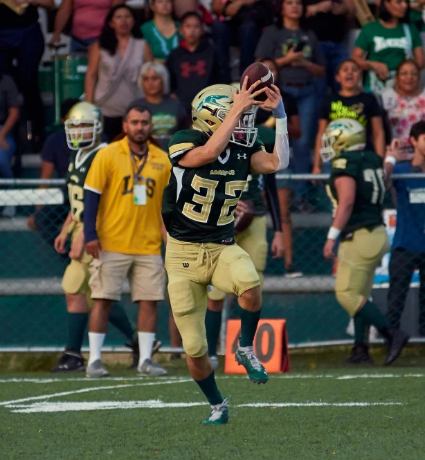 a football player holding a football during a game