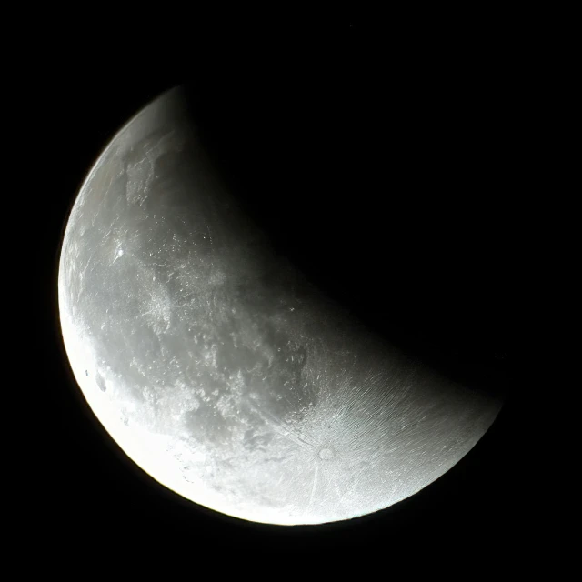 the half moon seen through a dark sky