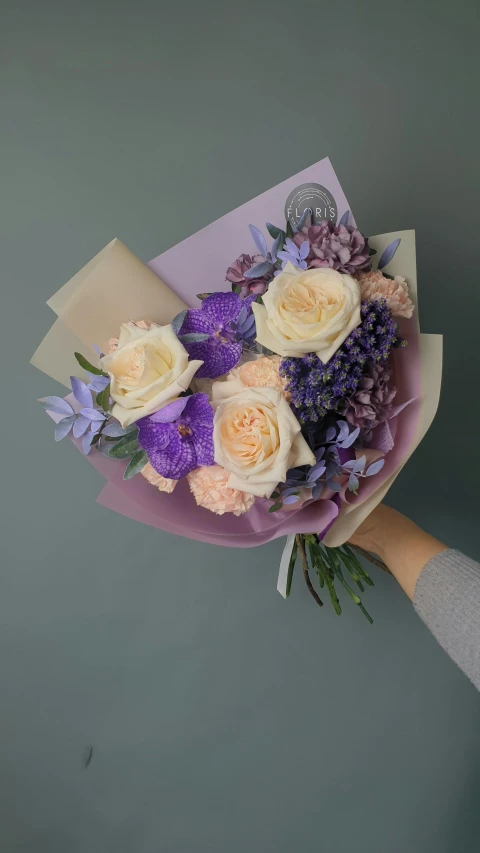 a person is holding a bunch of flowers