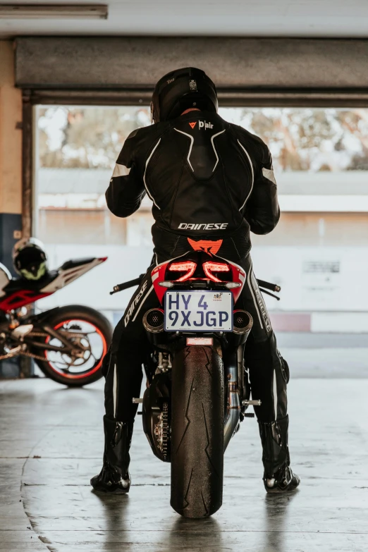 a person in full leather on a motorcycle