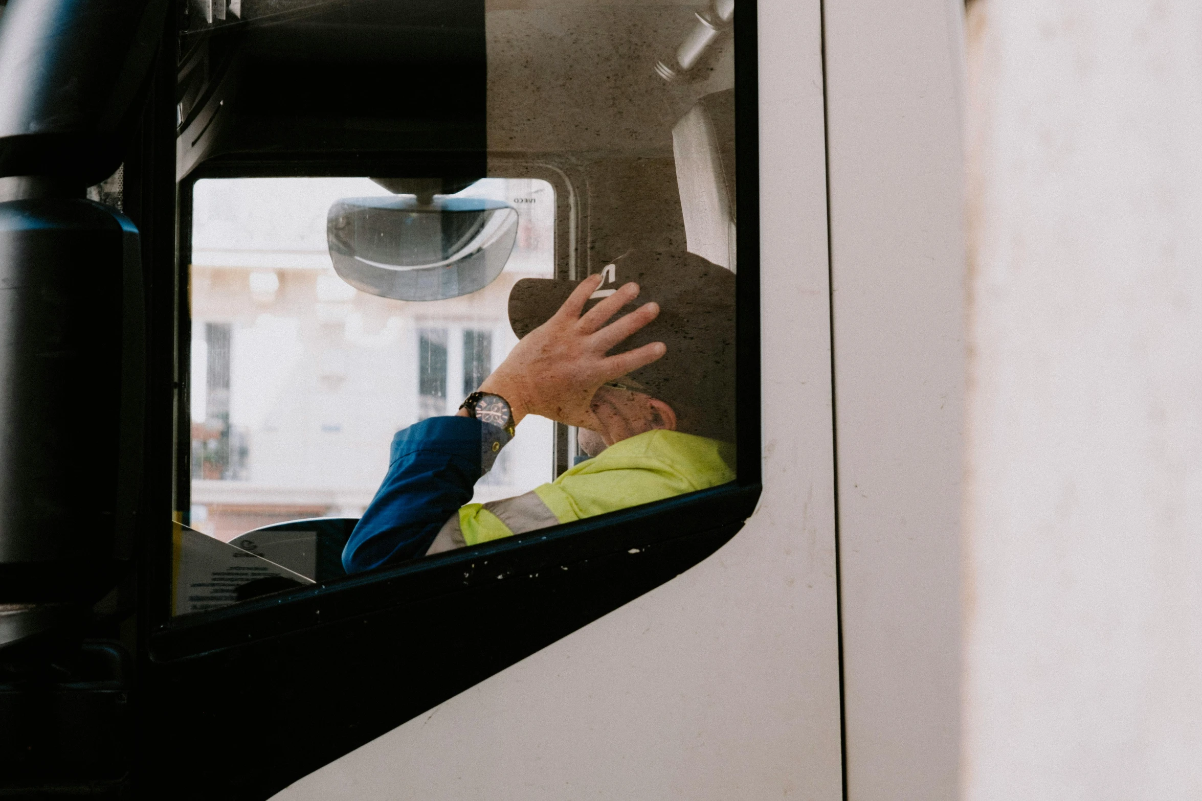 two people in the back seat of a bus