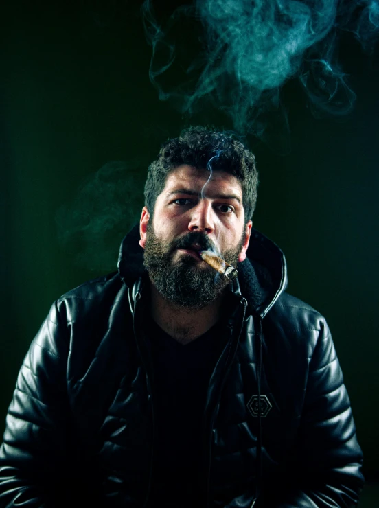 a man with a beard smoking a cigarette