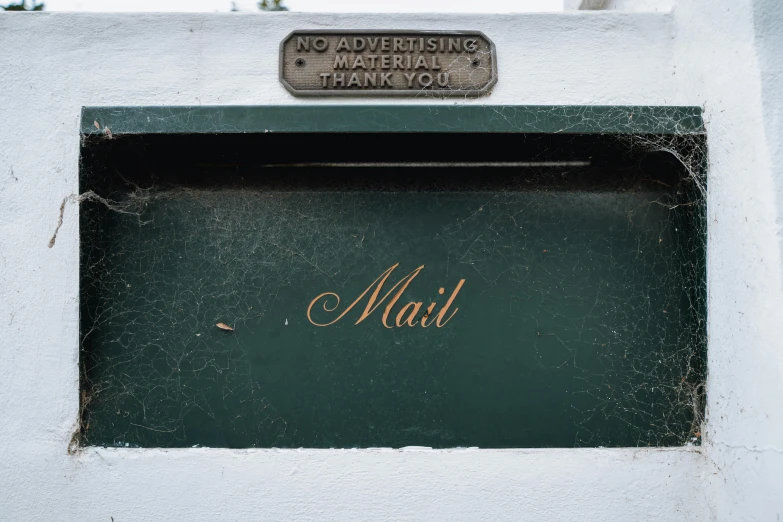 a metal sign that says mail above a door