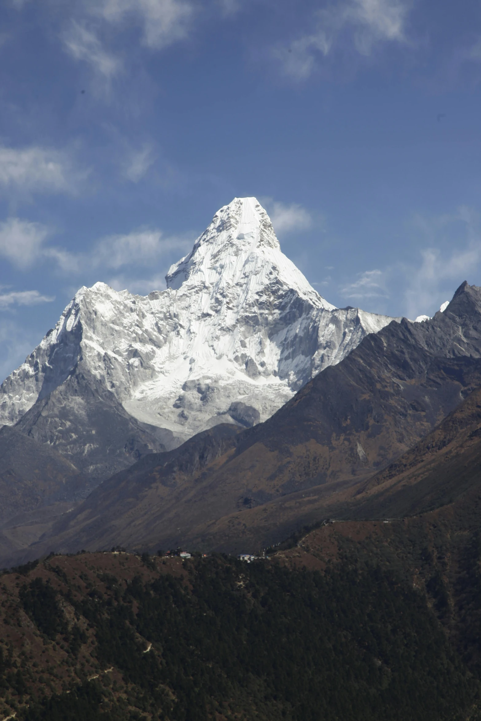 a snowy mountain is in the background with a house below