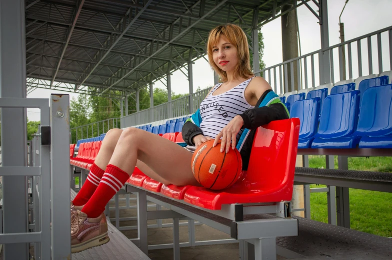 a lady in red boots is posing on a bench