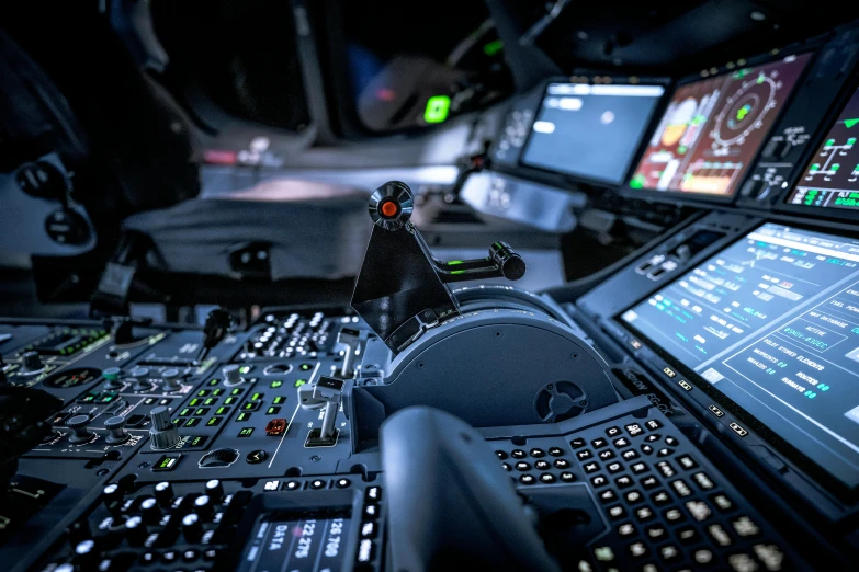 the control desk in a space shuttle with many screens on it