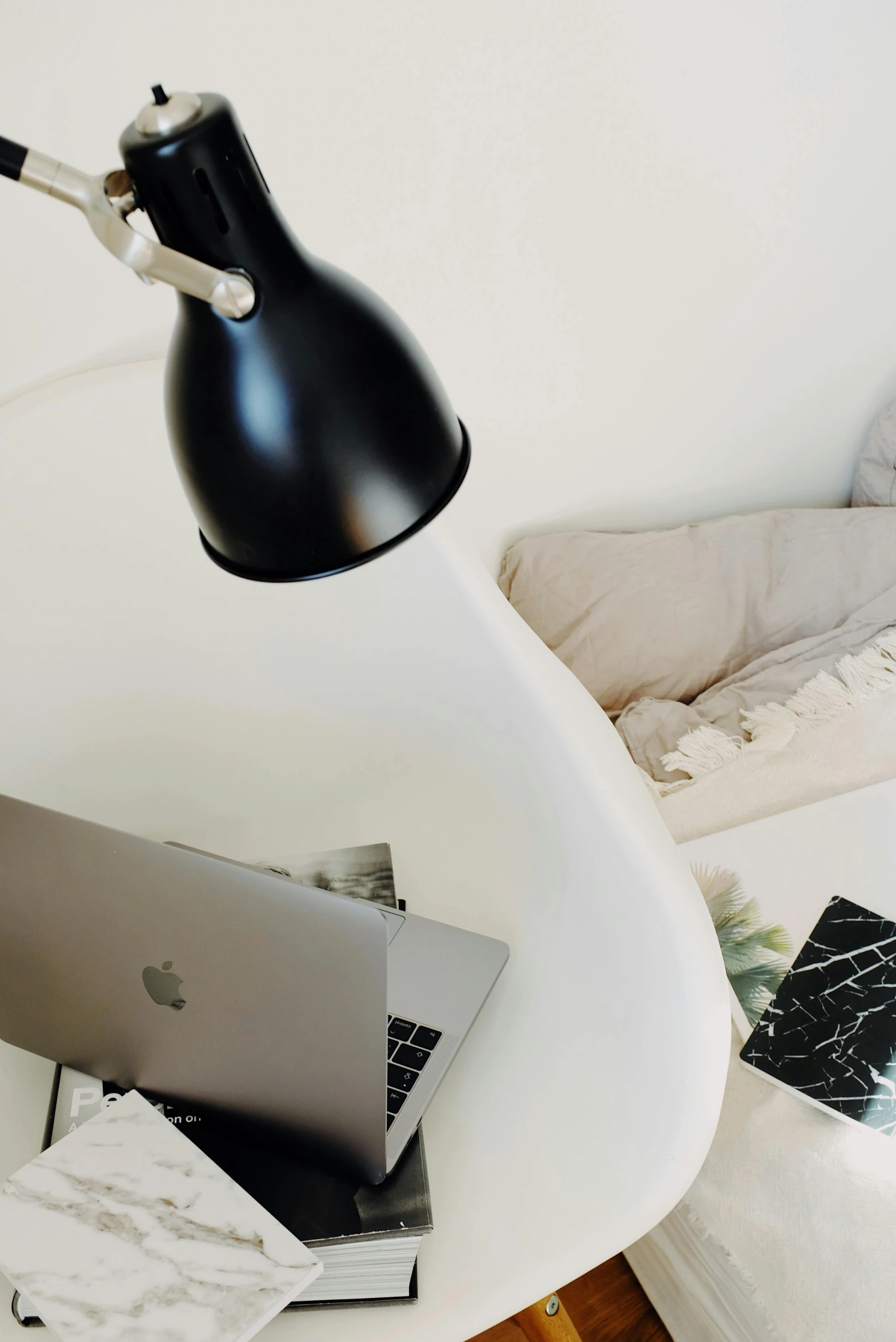 an apple laptop on a black and white lamp