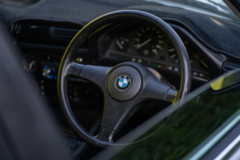 a steering wheel is shown with a black leather handle