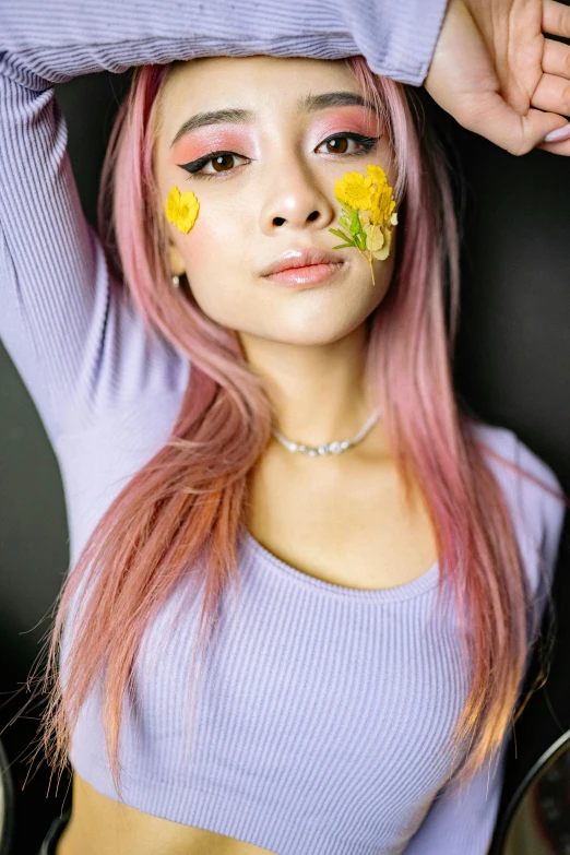 an asian woman with yellow flowers on her face