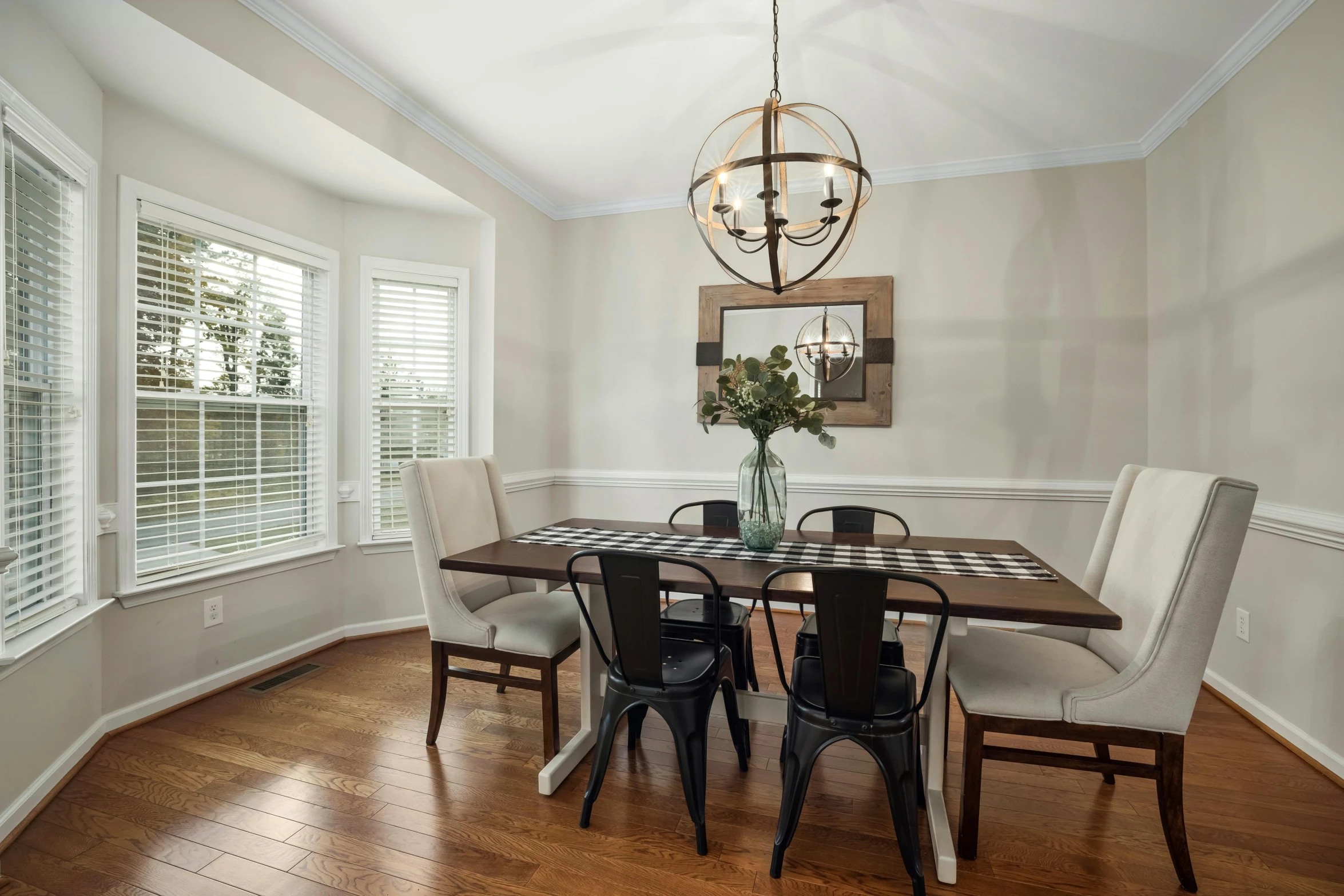 a well decorated dining area with a table and chairs