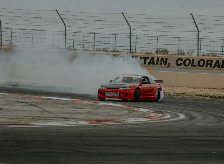 the car is driving down the track on its own wheels