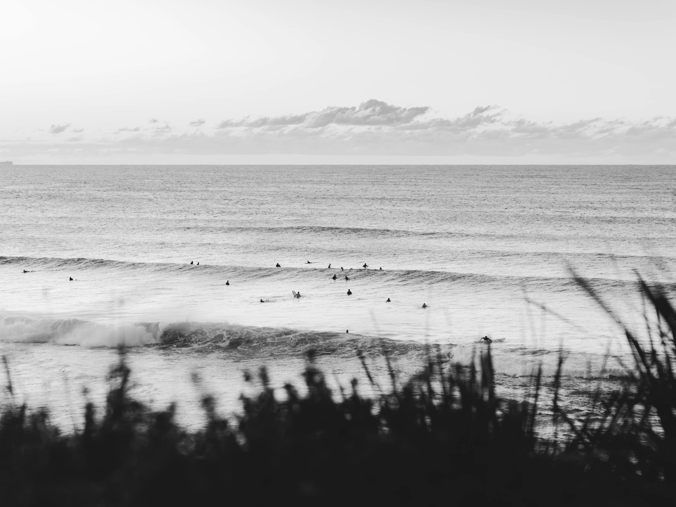 a bunch of surfers in the water at the beach