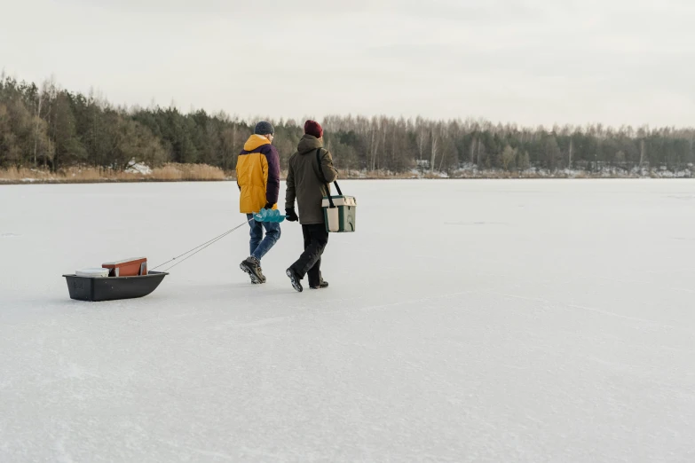 the two people are walking their dog through the snow