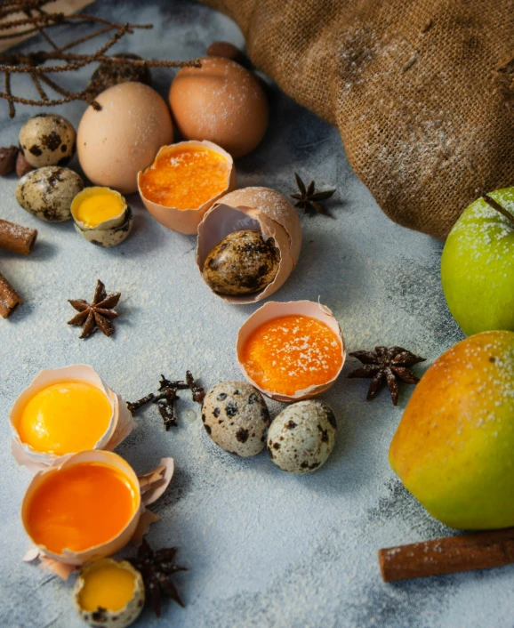 there are various ingredients on the table including eggs, cinnamons, and spices