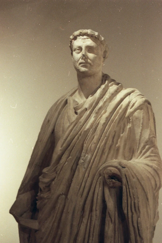 a black and white pograph of a statue of a person with a scarf