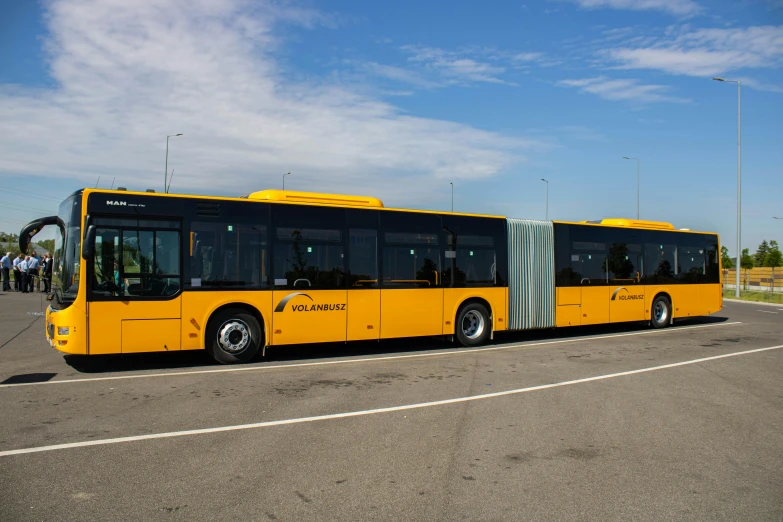 a yellow bus parked by itself in the parking lot