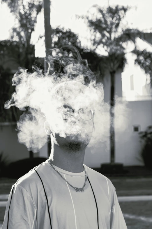 a black and white pograph of a man with a cigarette