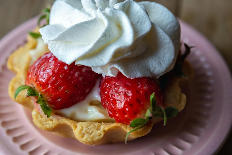 some strawberry pie is topped with whipped cream