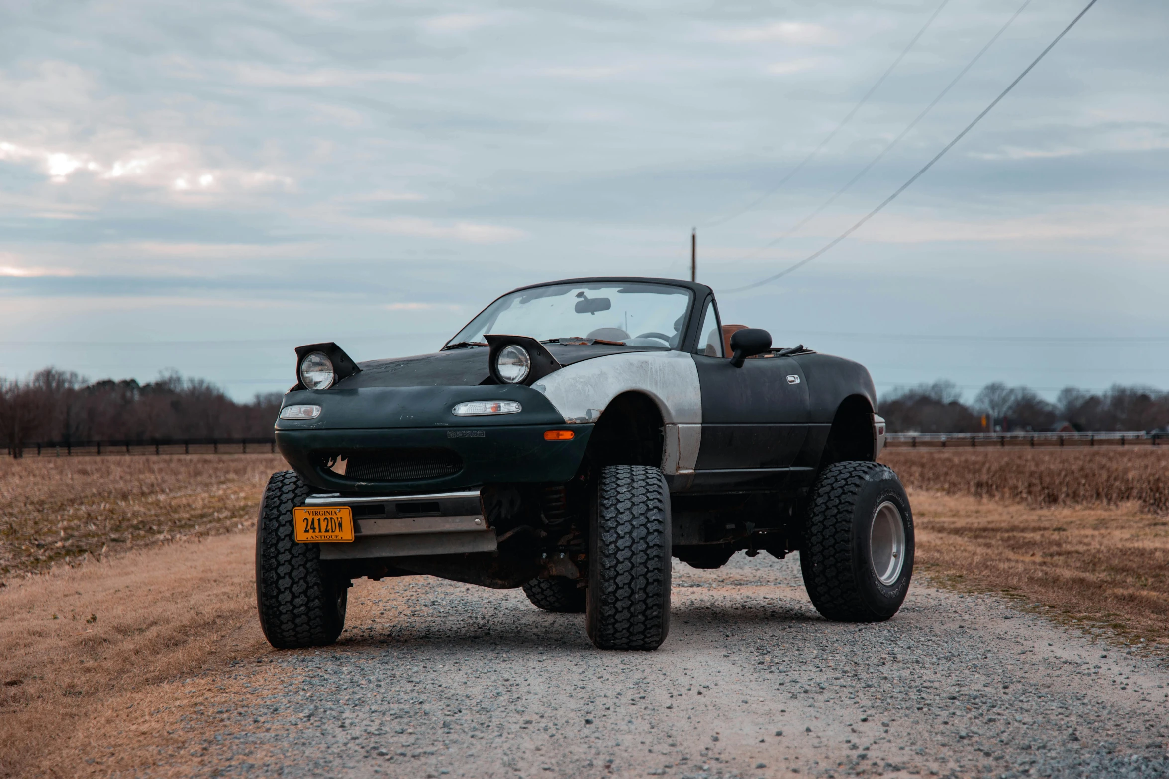 an off - road vehicle driving down a dirt road