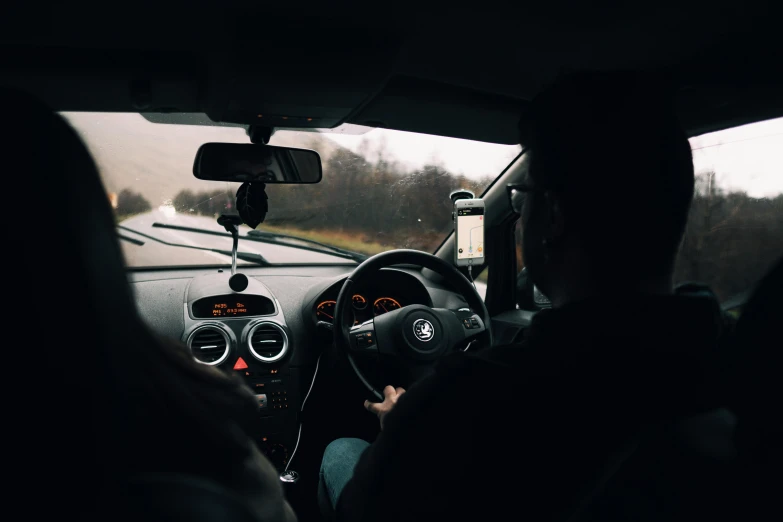 a man driving a small truck with a dashboard