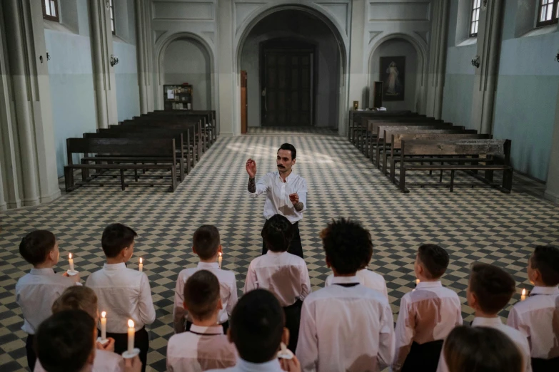 the priest is making his way down the aisle of the church