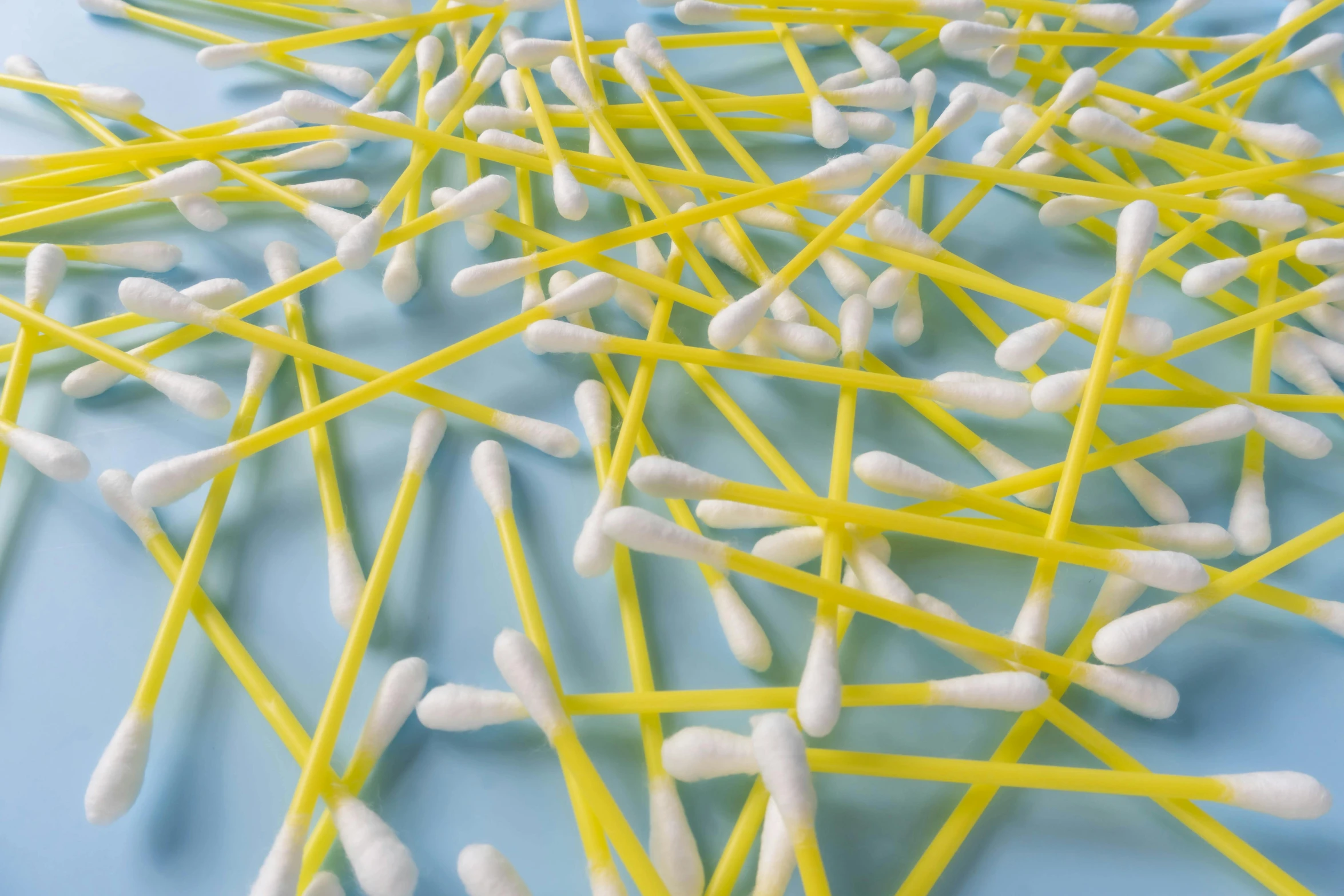 a close up s of toothpicks stuck in a blue surface