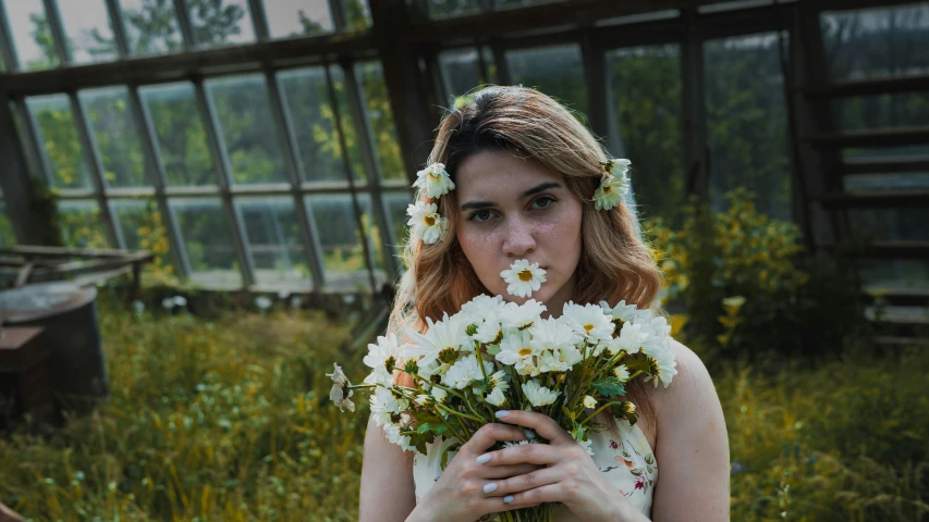 a woman holding flowers in front of her face