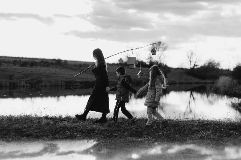 two adults and a child playing with a kite