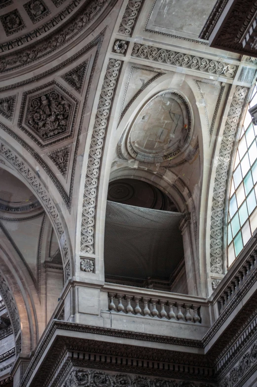 looking up at ornate architecture and window in the interior