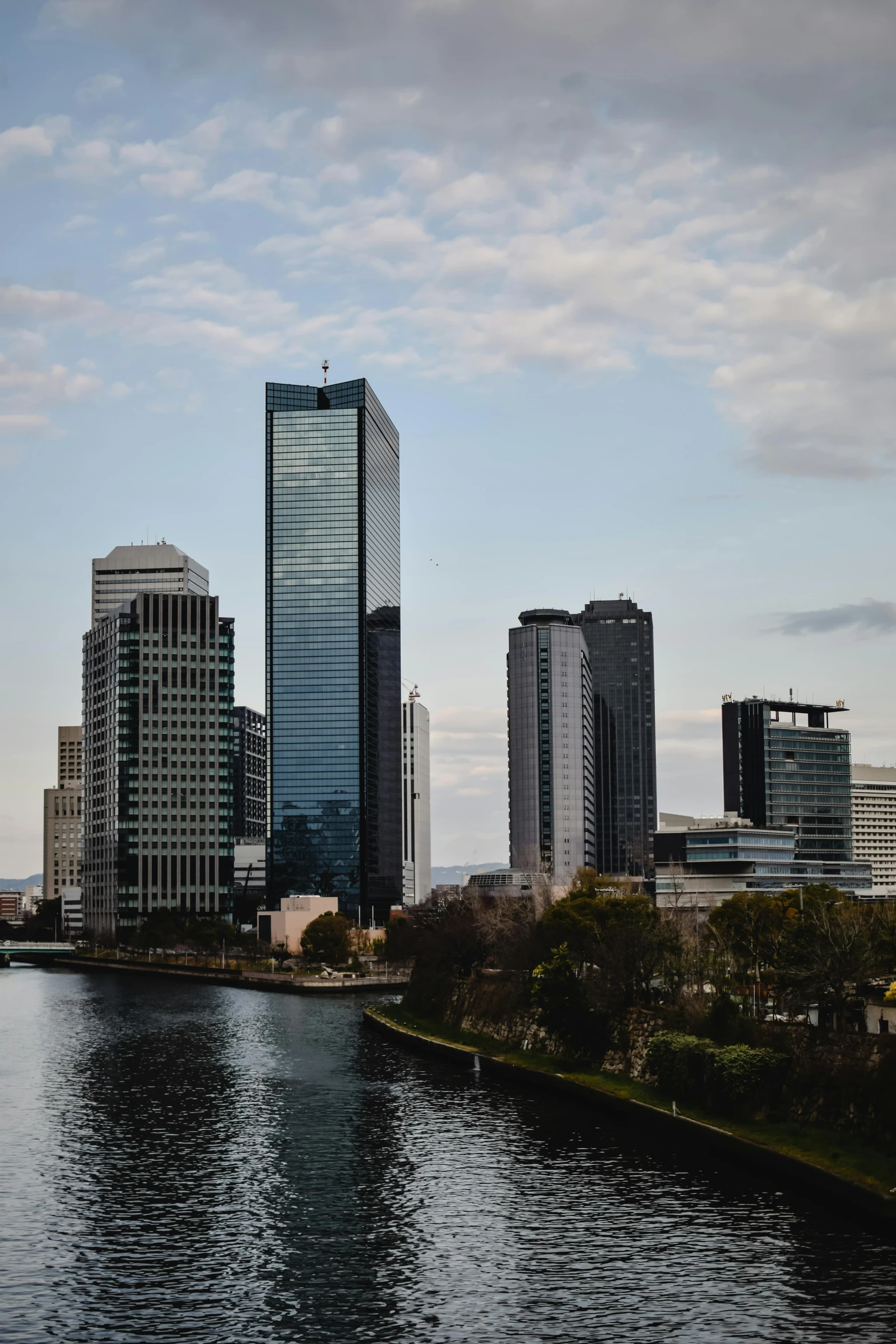 a view of some very tall buildings near the water