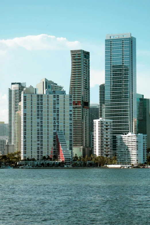 some very tall buildings next to the water