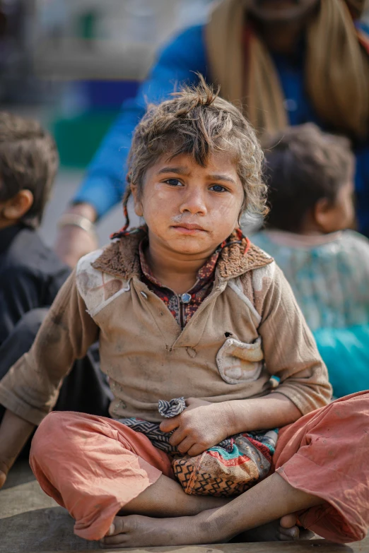 a child sitting on the ground with two feet