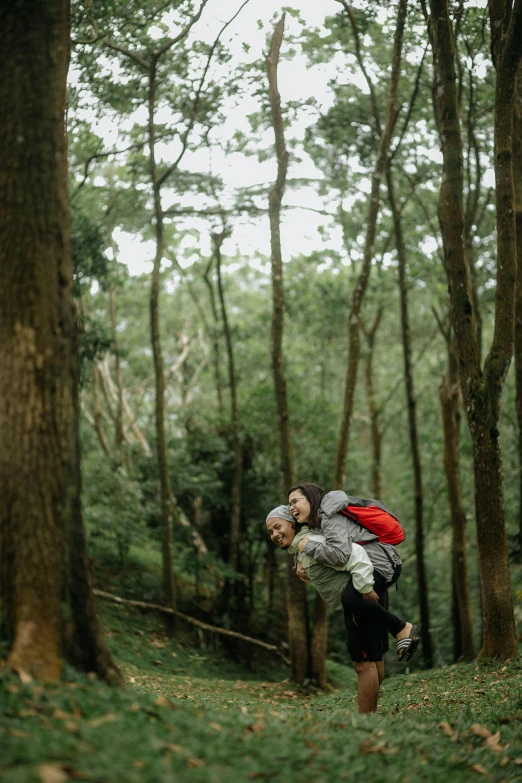 two men walking through a forest holding hands