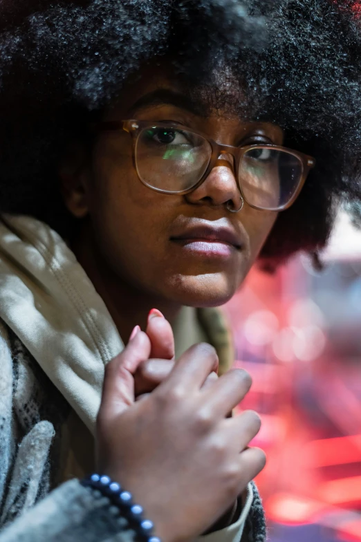 woman with an afro holding a small wooden object