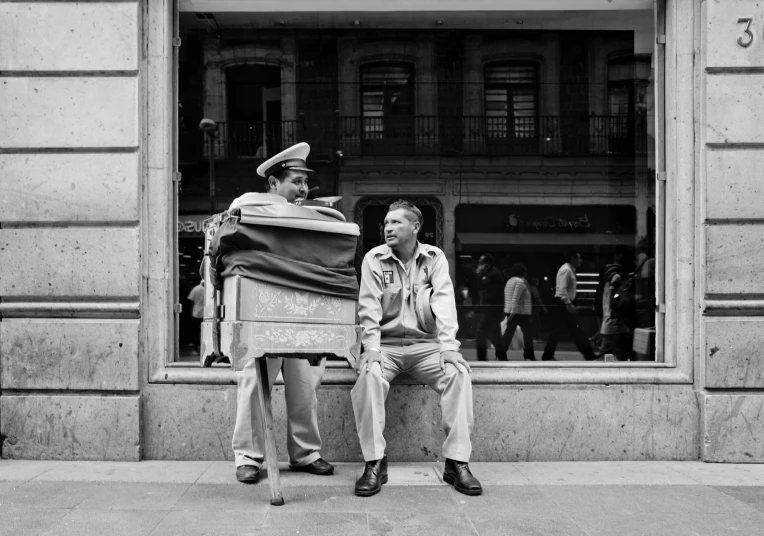 an image of two men sitting on a bench