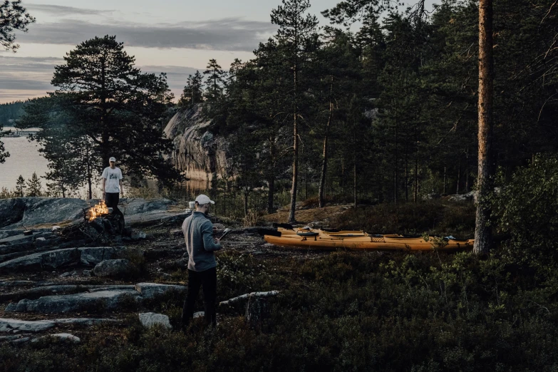 some people standing on a rocky shore by the ocean