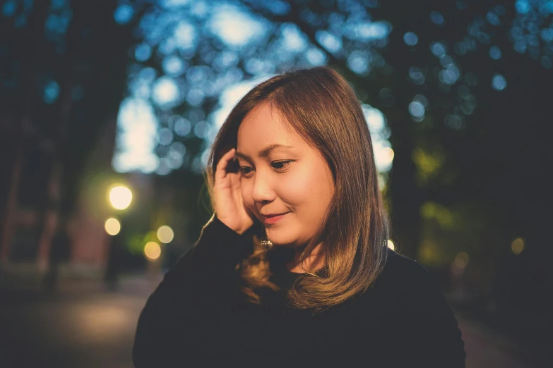 a woman on her cellphone while walking in the night