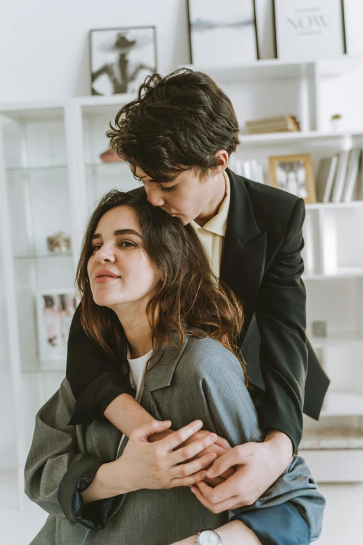 two people hug while posing for a po